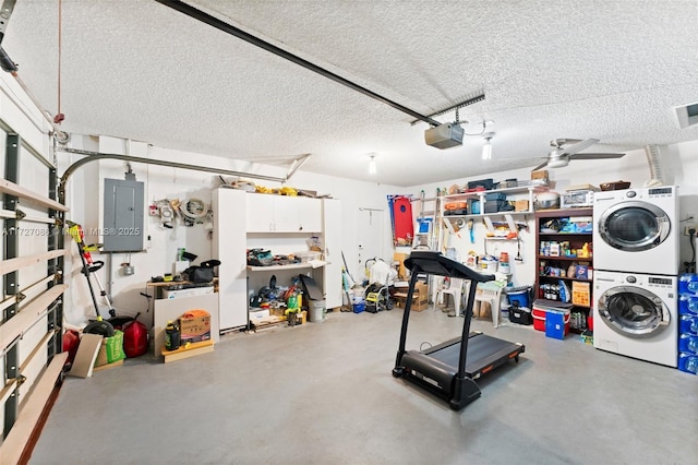 garage with ceiling fan, stacked washer / dryer, a garage door opener, and electric panel