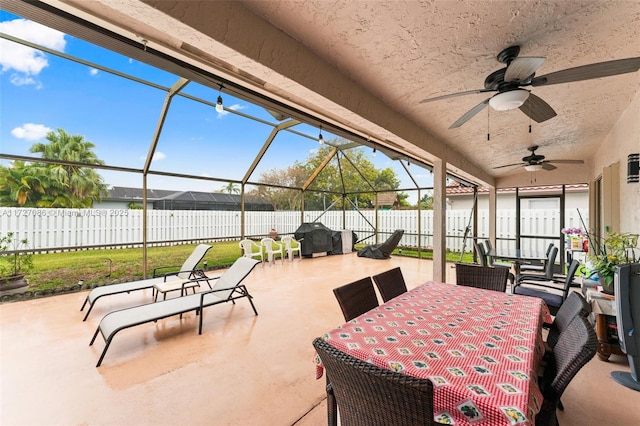 view of patio / terrace featuring ceiling fan, a lanai, and area for grilling