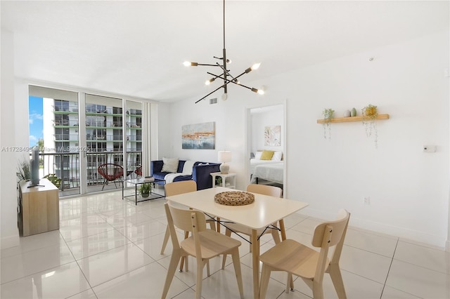 dining space featuring light tile patterned flooring, a chandelier, and a wall of windows