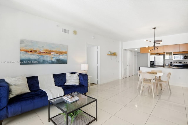 tiled living room with a chandelier