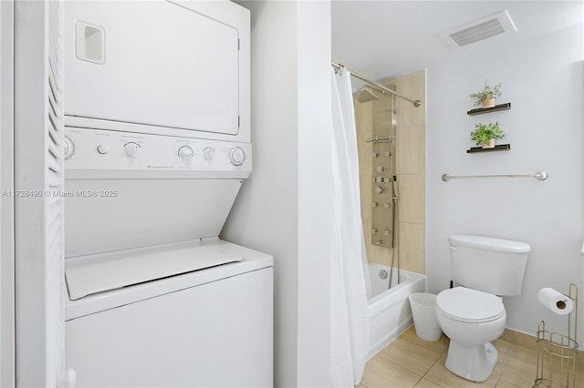 bathroom with shower / tub combo, toilet, and stacked washer / dryer