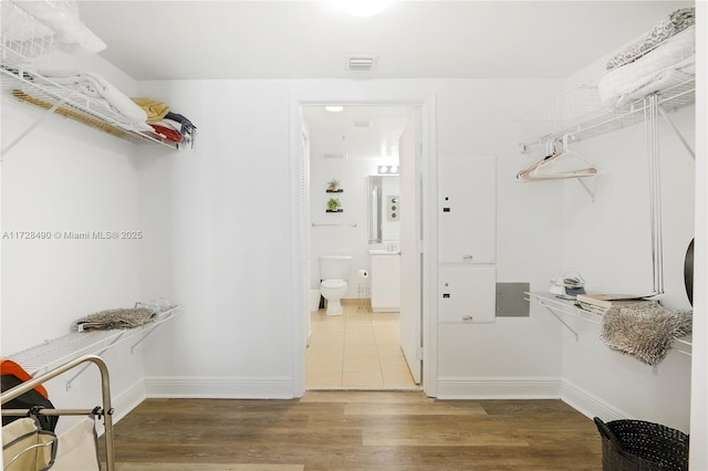 spacious closet with hardwood / wood-style flooring