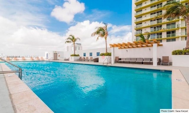 view of swimming pool featuring a pergola and a patio