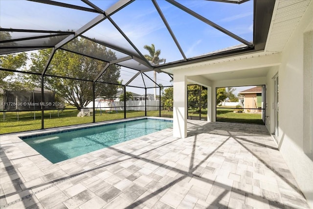 view of swimming pool with a lanai, a lawn, and a patio