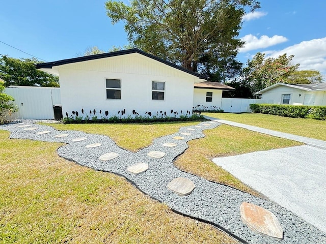 view of side of home with a lawn