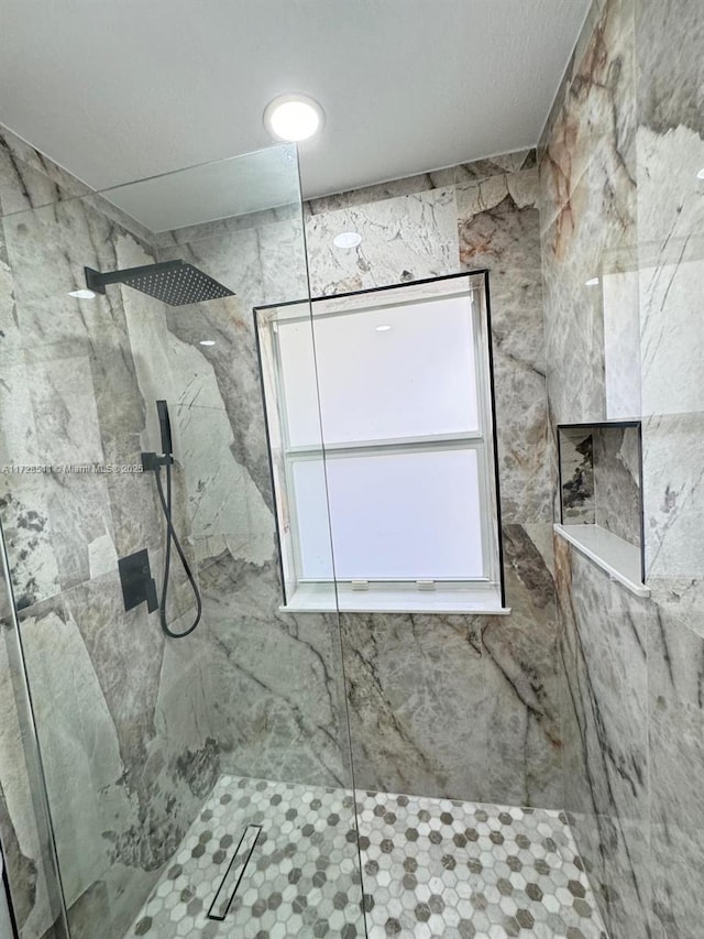 bathroom featuring a tile shower