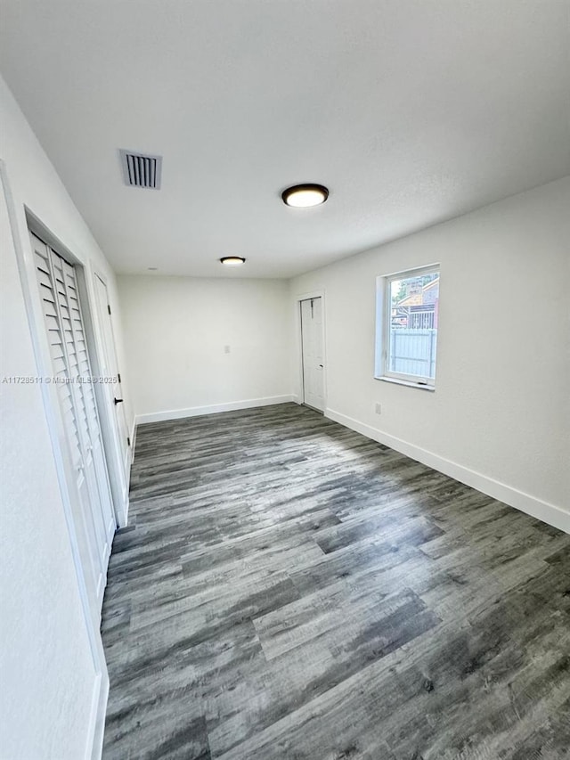 unfurnished bedroom featuring dark hardwood / wood-style floors