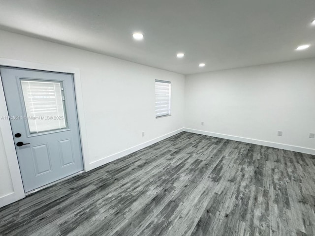 empty room featuring dark hardwood / wood-style floors and plenty of natural light