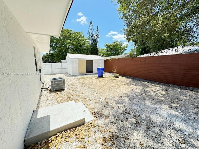 view of yard with a storage unit and central air condition unit