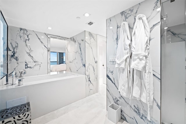 bathroom featuring tile walls and a shower