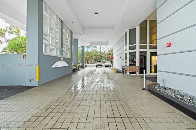 interior space with tile patterned floors and a wall of windows