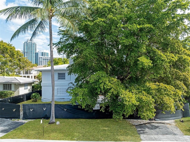 view of side of home with a yard