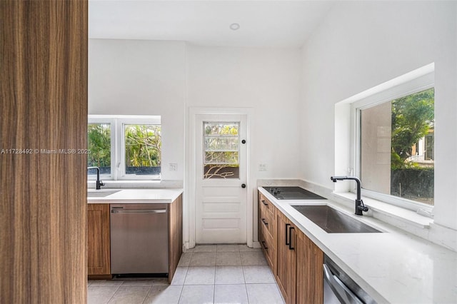 kitchen with light tile patterned floors, sink, and stainless steel dishwasher