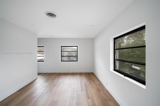 spare room with hardwood / wood-style flooring