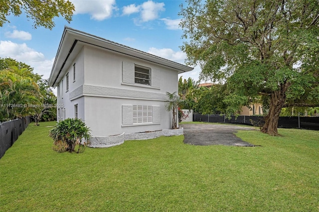 back of house with a patio area and a yard