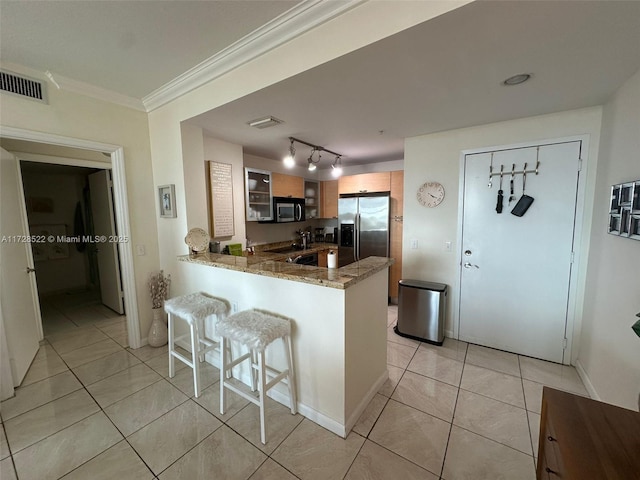 kitchen with a breakfast bar, light stone counters, appliances with stainless steel finishes, ornamental molding, and kitchen peninsula