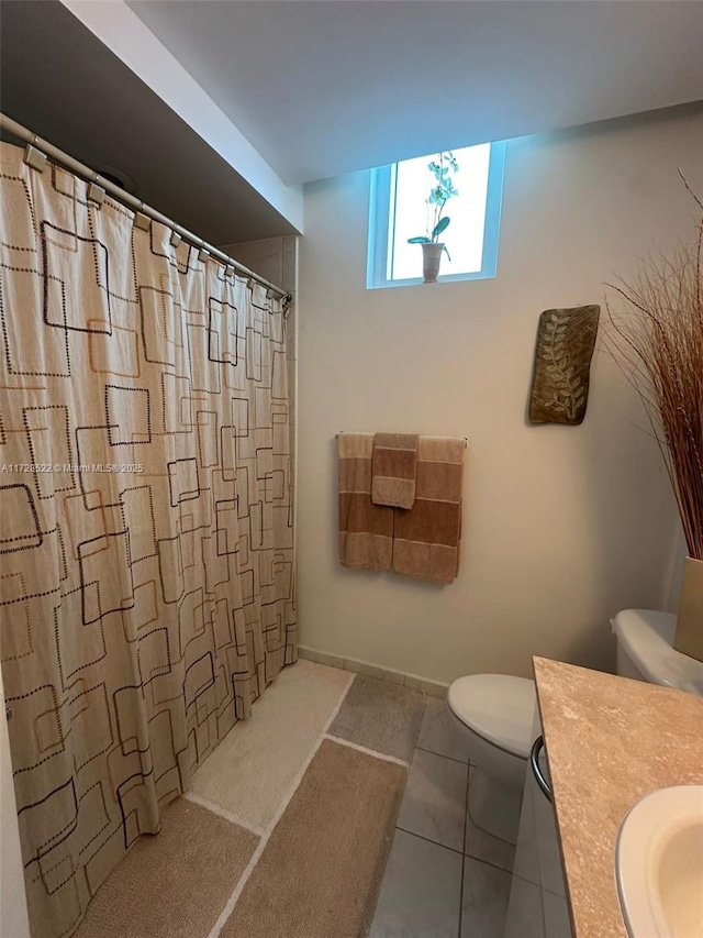 bathroom featuring vanity, a shower with curtain, tile patterned floors, and toilet