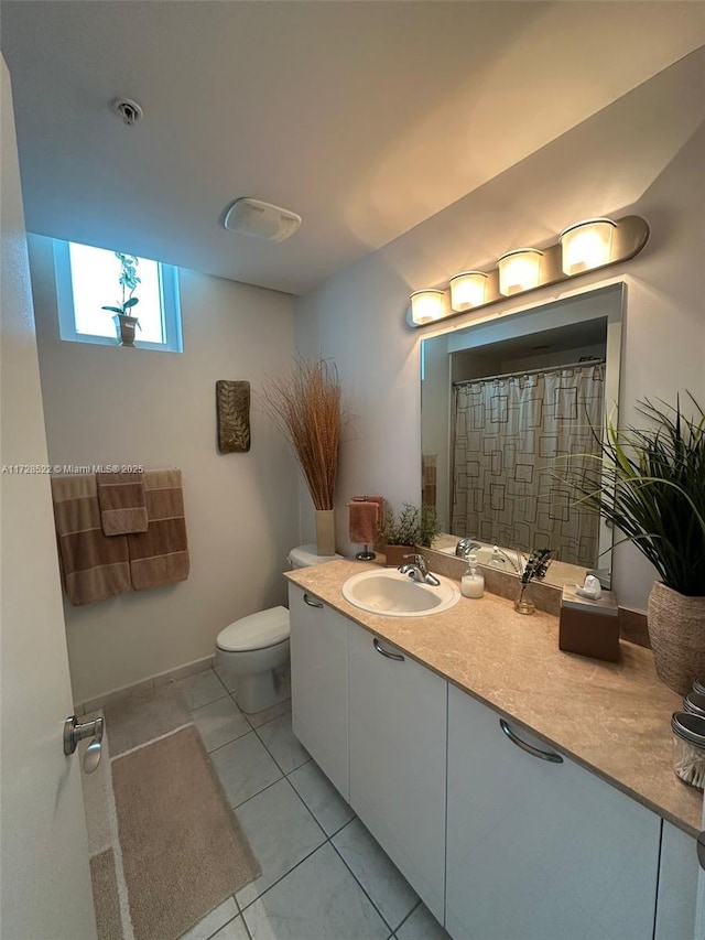 bathroom with vanity, tile patterned flooring, and toilet