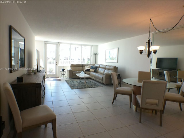 living room featuring a wall of windows, a chandelier, and light tile patterned flooring