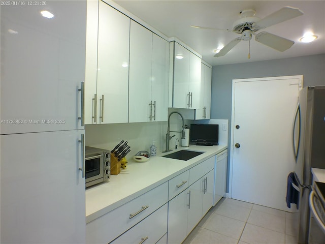 kitchen featuring sink, light tile patterned floors, white cabinets, and white appliances