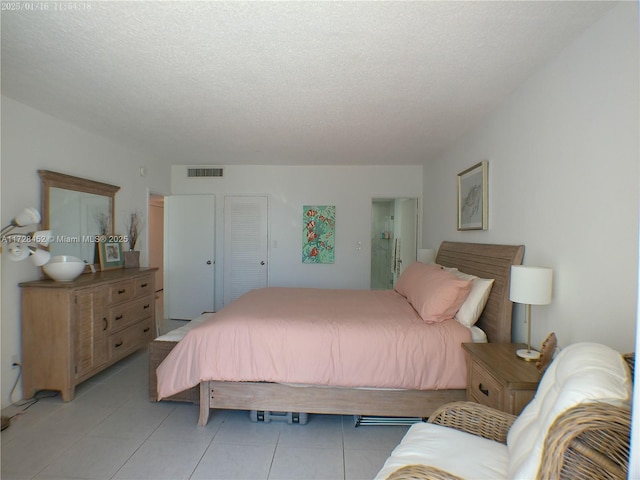 tiled bedroom with a textured ceiling