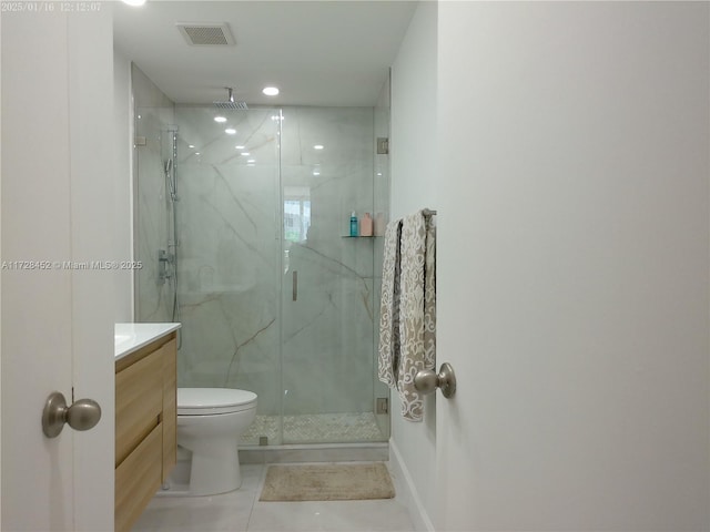 bathroom with tile patterned flooring, an enclosed shower, vanity, and toilet