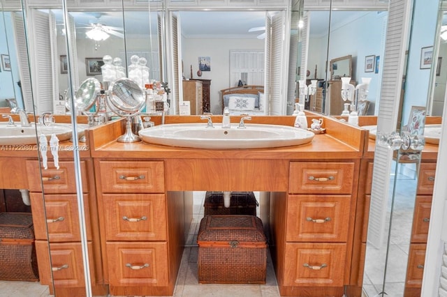 bathroom featuring ceiling fan, vanity, tile patterned floors, and crown molding