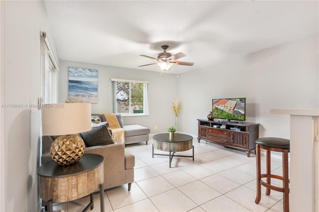 living room featuring ceiling fan and light tile patterned flooring