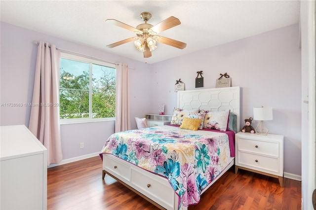 bedroom with dark hardwood / wood-style floors and ceiling fan