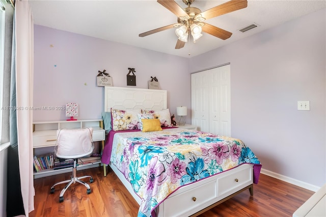 bedroom featuring hardwood / wood-style flooring, a closet, and ceiling fan