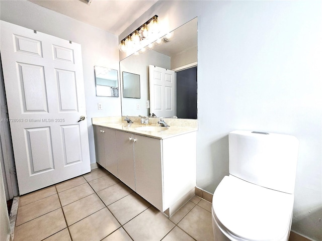 bathroom featuring tile patterned floors, toilet, and vanity