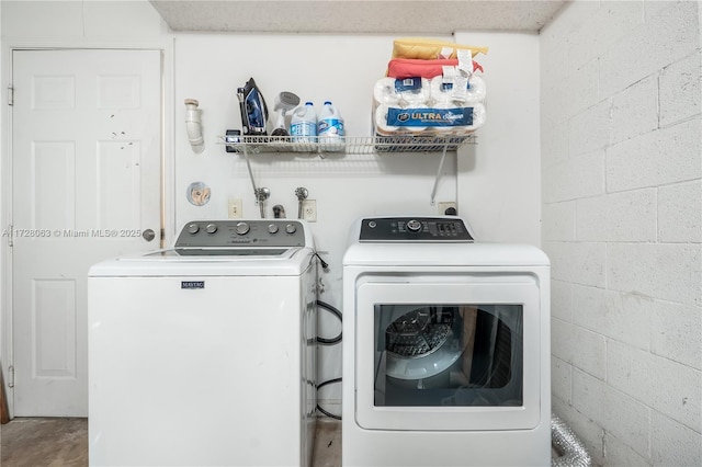 clothes washing area with washing machine and clothes dryer