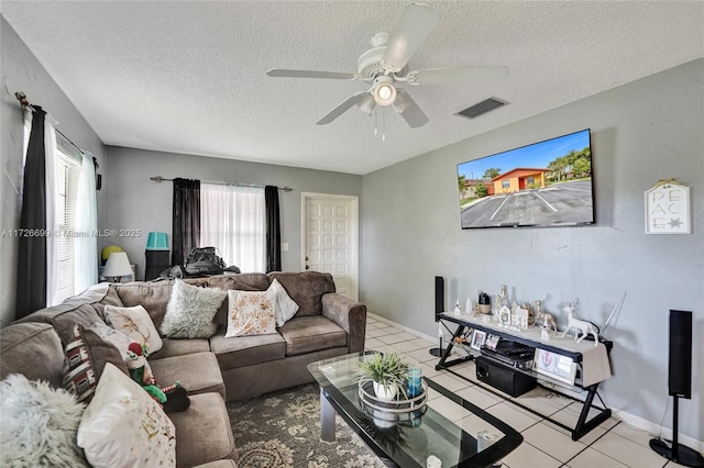 tiled living room featuring a textured ceiling and ceiling fan