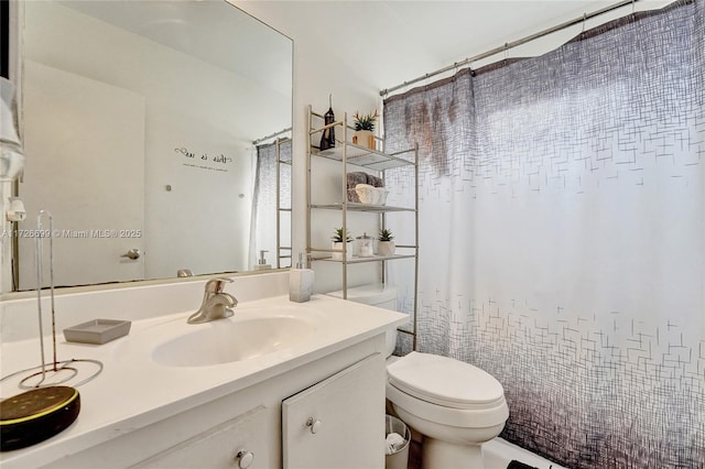 bathroom featuring toilet and vanity