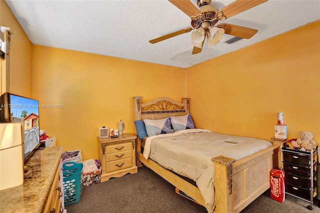 carpeted bedroom with ceiling fan and a textured ceiling