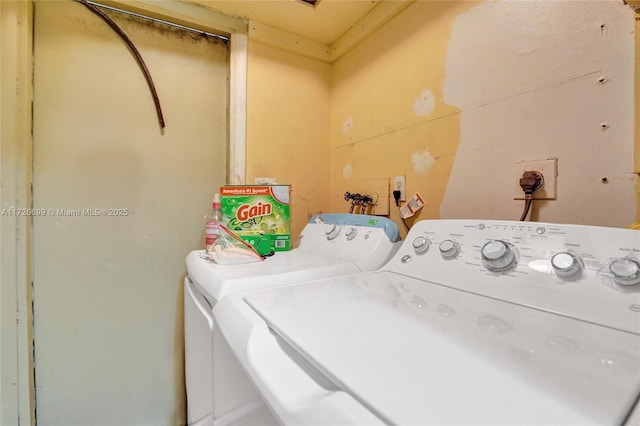 clothes washing area with washer and dryer