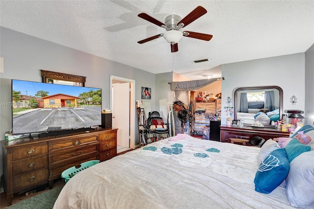 bedroom featuring a textured ceiling and ceiling fan