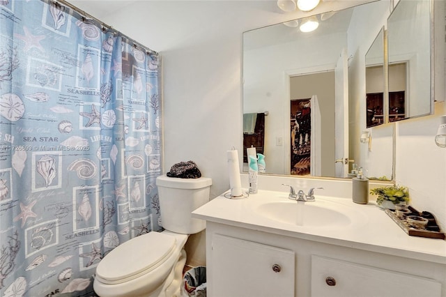 bathroom featuring toilet and vanity