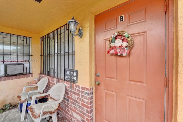 doorway to property featuring cooling unit