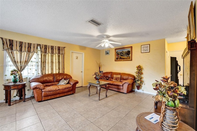 tiled living room featuring a textured ceiling and ceiling fan