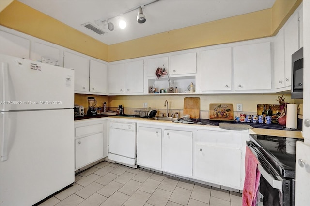 kitchen featuring sink, white appliances, white cabinets, and light tile patterned flooring