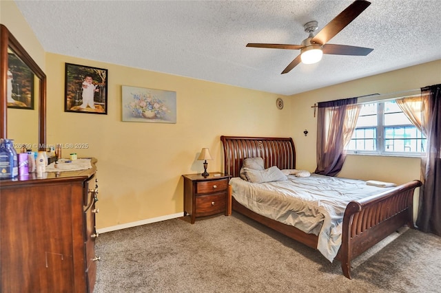 carpeted bedroom featuring a textured ceiling and ceiling fan