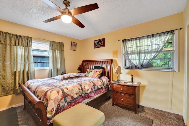 bedroom featuring a textured ceiling, carpet floors, and ceiling fan