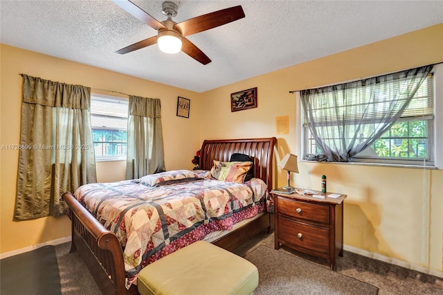 carpeted bedroom featuring a textured ceiling and ceiling fan