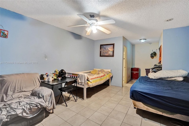 tiled bedroom with ceiling fan and a textured ceiling