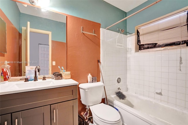 full bathroom with vanity, toilet, and tiled shower / bath combo