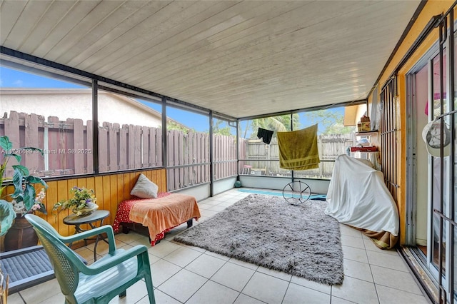 sunroom / solarium featuring wood ceiling