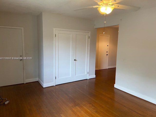 unfurnished bedroom featuring ceiling fan and dark hardwood / wood-style floors