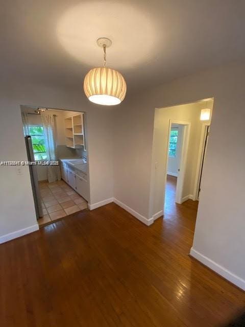 unfurnished dining area featuring sink and light wood-type flooring