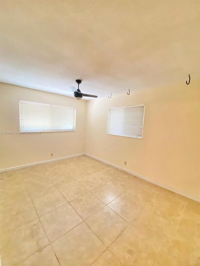 empty room featuring light tile patterned flooring and ceiling fan